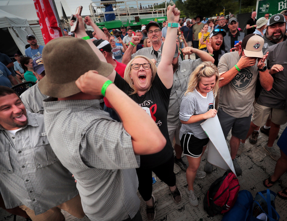 <strong>Nuts N' Butts team members celebrate their win in the ribs division during the awards ceremony on the final day of the 2019 Memphis in May World Championship Barbecue Cooking Contest at Tom Lee Park on May, 18, 2019.</strong> (Jim Weber/Daily Memphian)