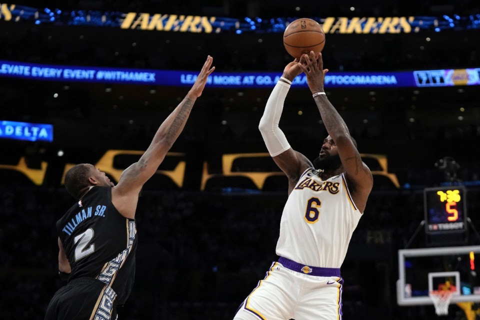 <strong>Los Angeles Lakers forward LeBron James (right), shoots as Memphis Grizzlies forward Xavier Tillman defends during the first half in Game 3 of a first-round NBA basketball playoff series Saturday, April 22, 2023, in Los Angeles.</strong> (Mark J. Terrill/AP)