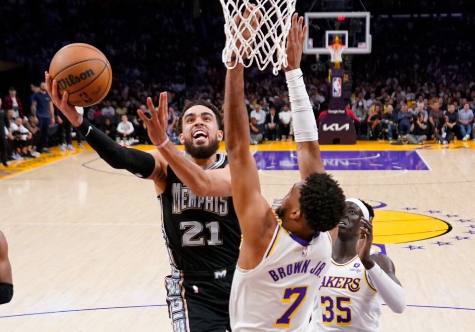 <strong>Memphis Grizzlies guard Tyus Jones (left) shoots as Los Angeles Lakers forward Troy Brown Jr. and forward Wenyen Gabriel defend during the first half in Game 3 of a first-round NBA basketball playoff series Saturday, April 22, 2023, in Los Angeles.</strong> (Mark J. Terrill/AP)