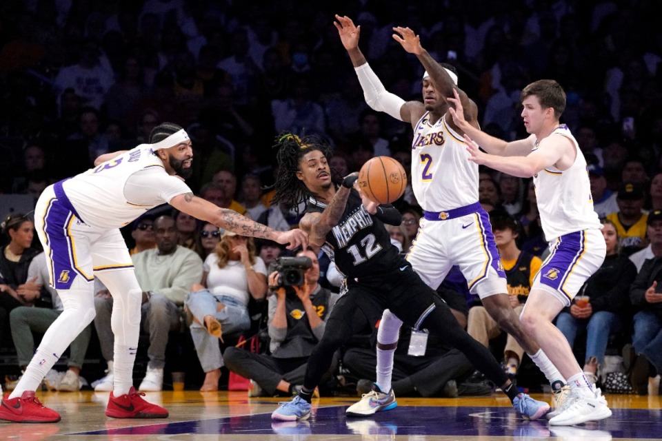 <strong>Memphis Grizzlies guard Ja Morant tries to pass while under pressure from Los Angeles Lakers forward Anthony Davis, (left), forward Jarred Vanderbilt (second from right), and guard Austin Reaves during the second half in Game 3 of a first-round NBA basketball playoff series Saturday, April 22, 2023, in Los Angeles.</strong> (Mark J. Terrill/AP)