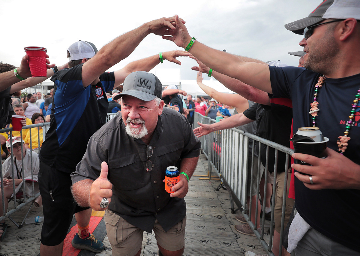 <strong>Dan Judd with Southern Smokers leads his team to the stage after winning the "Patio Porkers" division during the awards ceremony on the final day of the 2019 Memphis in May World Championship Barbecue Cooking Contest at Tom Lee Park on May, 18, 2019.</strong> (Jim Weber/Daily Memphian)