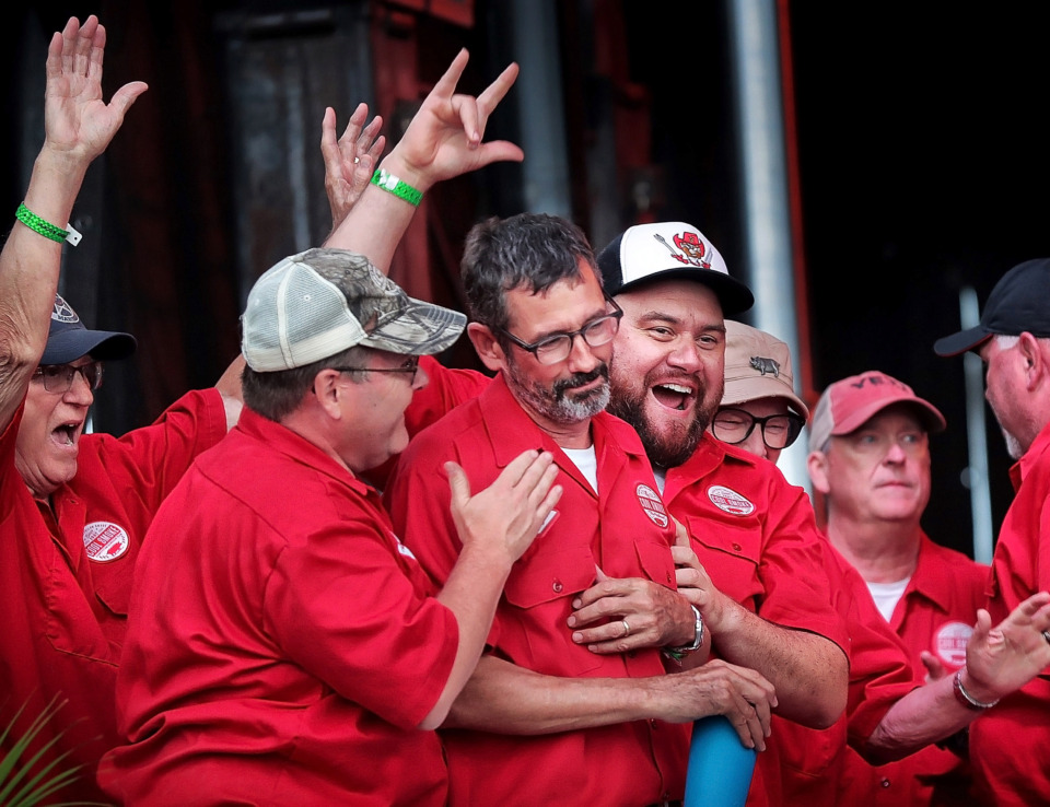 <strong>Pitmaster Tuffy Stone (center) is congratulated by team members after Cool Smoke was named Grand Champion during the awards ceremony for the 2019 Memphis in May World Championship Barbecue Cooking Contest at Tom Lee Park on May, 18, 2019.</strong> (Jim Weber/Daily Memphian)