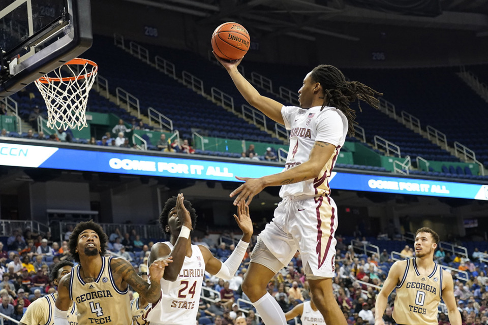 <strong>Florida State guard Caleb Mills (4) drives against Georgia Tech during the first half of an NCAA college basketball game at the Atlantic Coast Conference Tournament in Greensboro, N.C., March 7.</strong> (Chuck Burton/AP file)