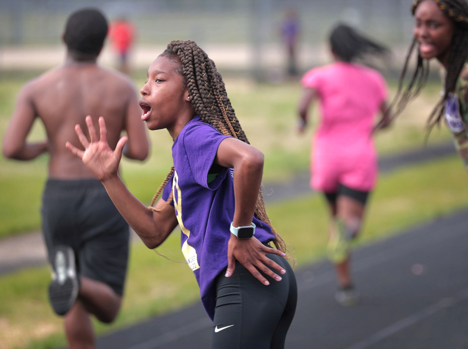 <strong>Southwind High standout sprinter Breanna Miles (left) cheers on her teammates during a workout at Southwind on April 17.</strong> (Jim Weber/Daily Memphian)