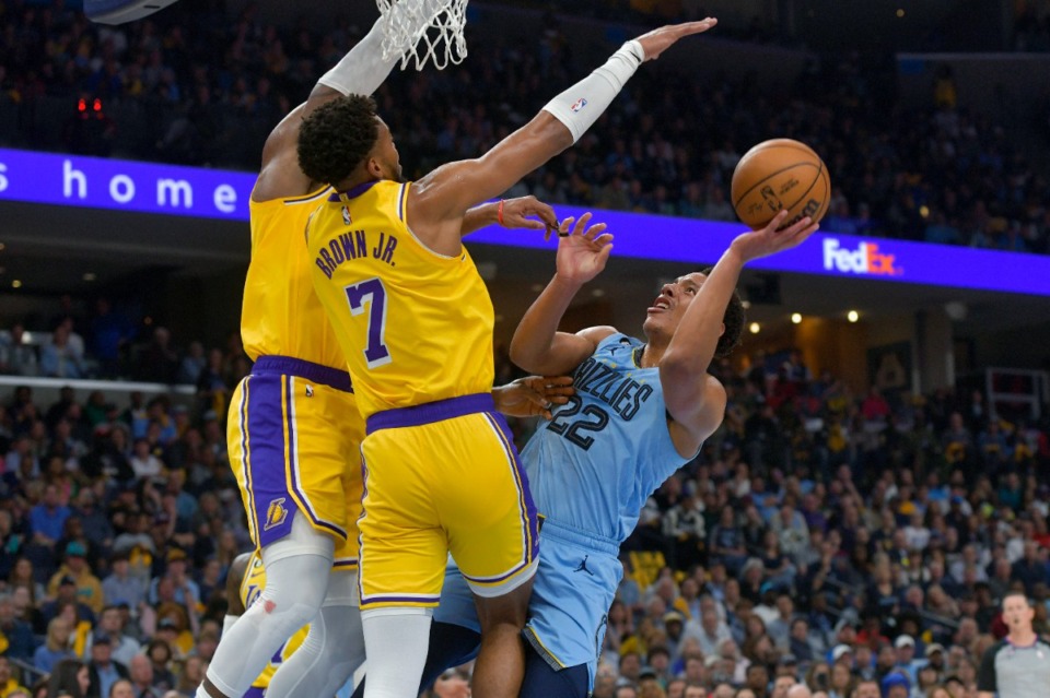<strong>Memphis Grizzlies guard Desmond Bane (22) shoots against Los Angeles Lakers forward Troy Brown Jr. (7) and basketball great LeBron James, left, on April 26.</strong>&nbsp;(Brandon Dill/AP)