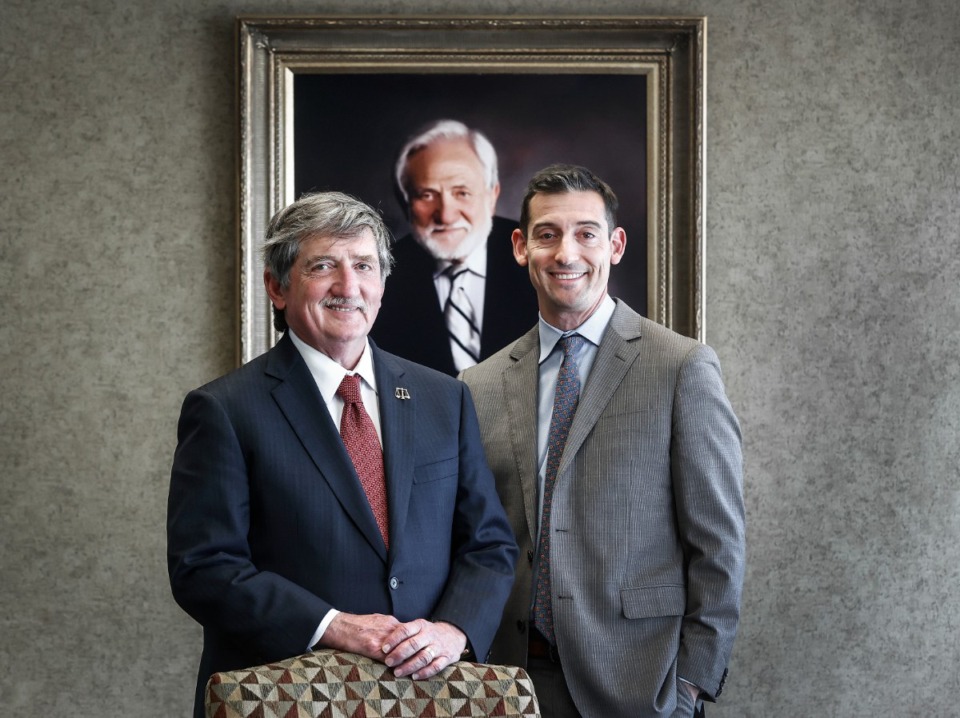 <strong>Attorney Leslie Ballin (left) stands with his son Blake Ballin, in front of a portrait of his late father Marvin Ballin in their Downtown offices.</strong> (Mark Weber/The Daily Memphian)
