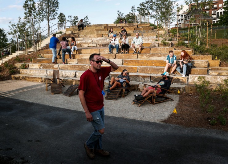 <strong>Music fans sit on a new stone seating feature at Tom Lee Park during the Beale Street Music Festival on Friday, May 5, 2023.</strong> (Mark Weber/The Daily Memphian)