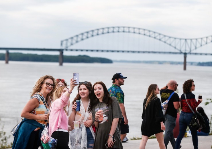<strong>With the Hernando DeSoto Bridge in the background, music fans take a selfie during the Beale Street Music Festival on Friday, May 5, 2023.</strong> (Mark Weber/The Daily Memphian)