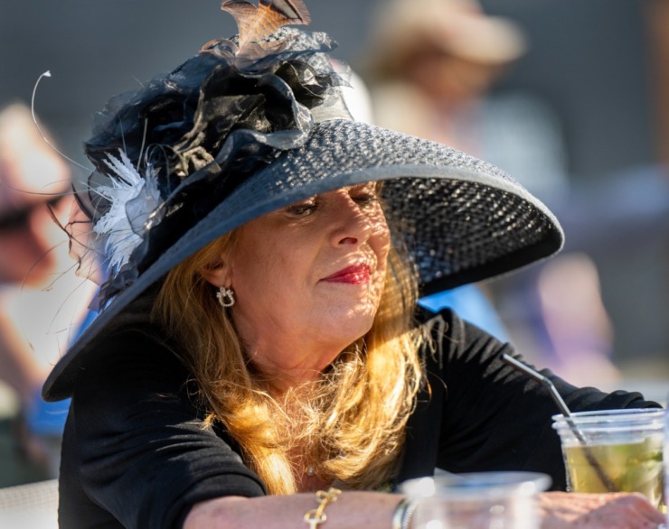 <strong>Ann Hammond&rsquo;s hat thelps block out the sunshine at the party, where guests watched the Kentucky Derby on a 20-foot-by-30-foot video wall at the Grove at GPAC. Mint juleps were served, also a Derby tradition.</strong> (Greg Campbell/Special to The Daily Memphian)