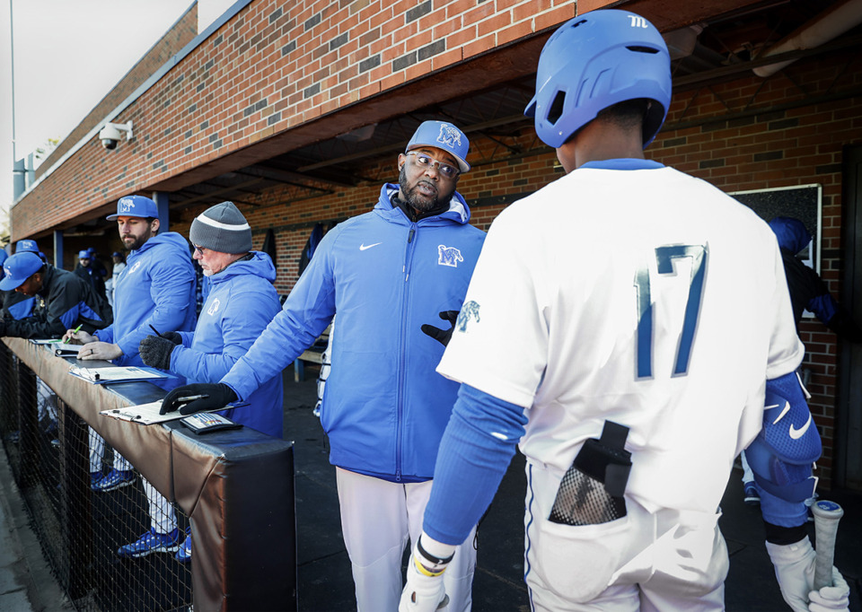 <strong>New University of Memphis baseball manager Kerrick Jackson (middle) chats with hitter Cameron Benson (right) in the dugout during action against Samford Feb. 17.</strong> (Mark Weber/The Daily Memphian file)