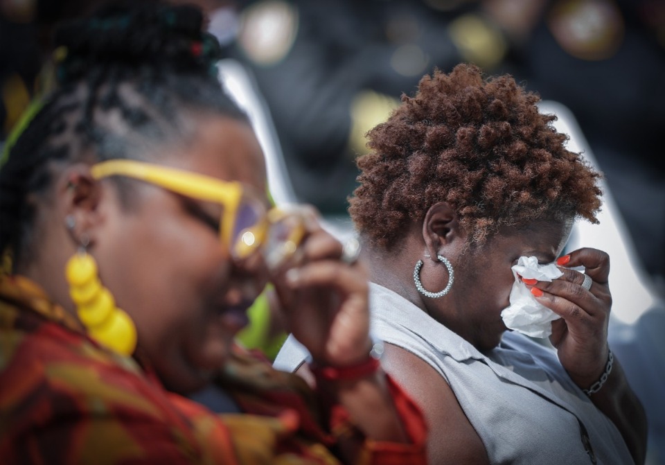 <strong>Cousins of fallen officer Geoffrey Redd, Katina Fletcher and Lakeasha Tate, wipe tears from their eyes at MPD's annual memorial program May 10, 2023.</strong> (Patrick Lantrip/The Daily Memphian)