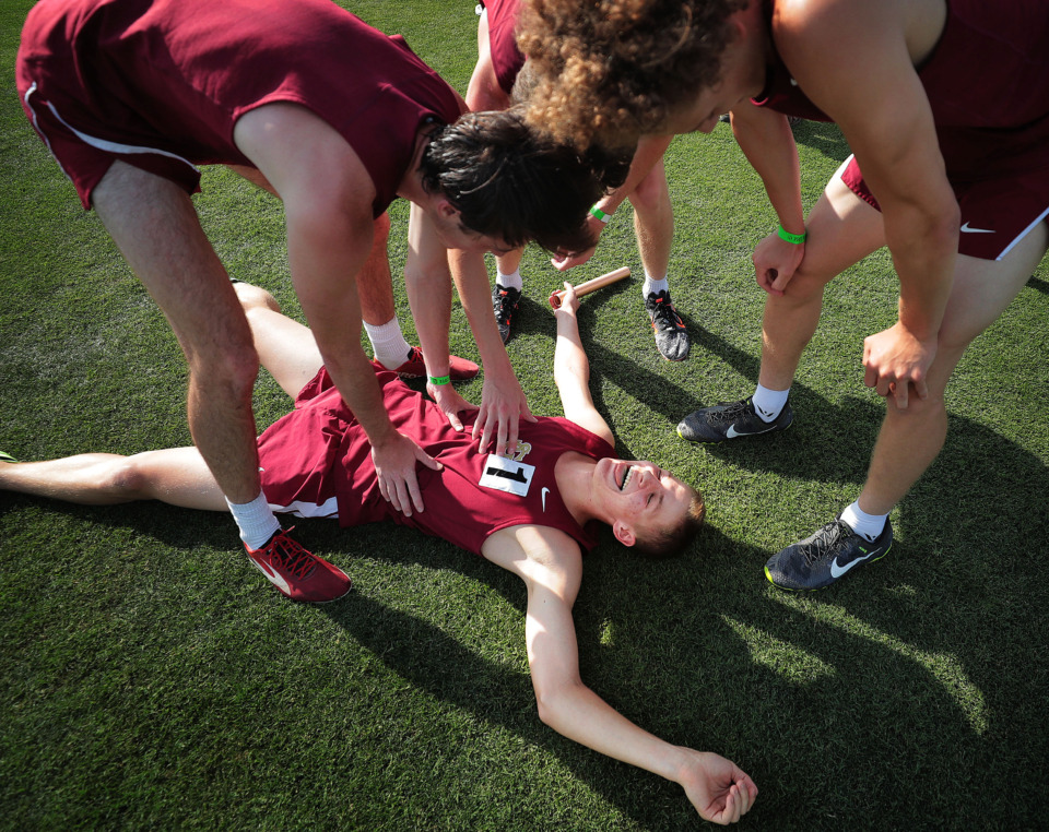 <strong>St. George's Jack Lange collapses after winning the Div II Class A 4X800M relay during the Spring Fling Div II state track finals at MTSU in Murfreesboro on May 22, 2019.</strong> (Jim Weber/Daily Memphian)