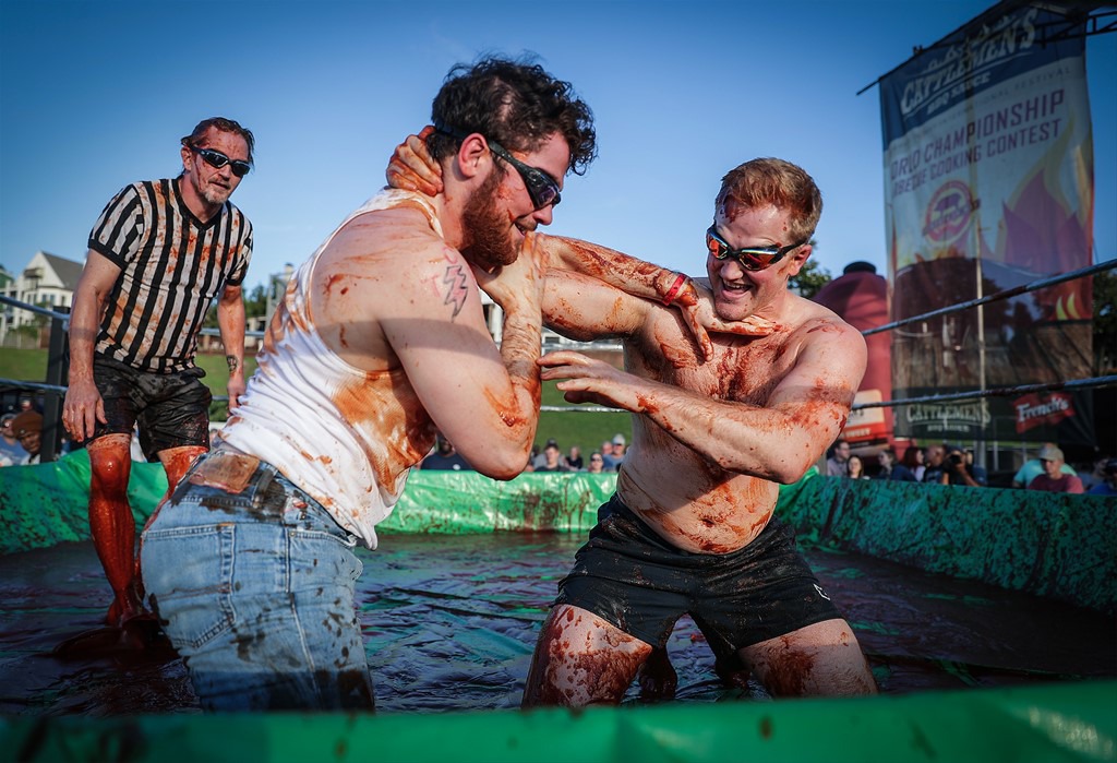<strong>Daniel Burke and Bryce Wittman show their stuff as they slop in the sauce in The World Championship Barbecue Cooking Contest&rsquo;s Sauce Wrestling event May 17, 2023.</strong> (Patrick Lantrip/The Daily Memphian)
