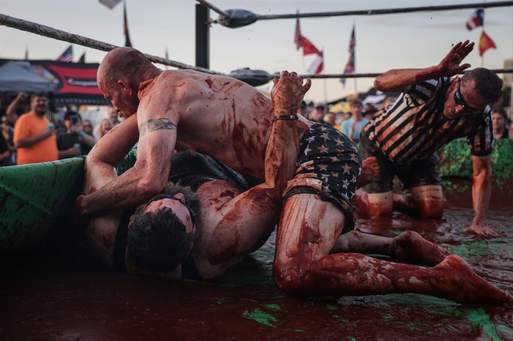 <strong>Jason Aldridge and Jeremy Adams look like extras in a horror movie as they turn sauce-red in The World Championship Barbecue Cooking Contest&rsquo;s Sauce Wrestling event May 17, 2023.</strong> (Patrick Lantrip/The Daily Memphian)