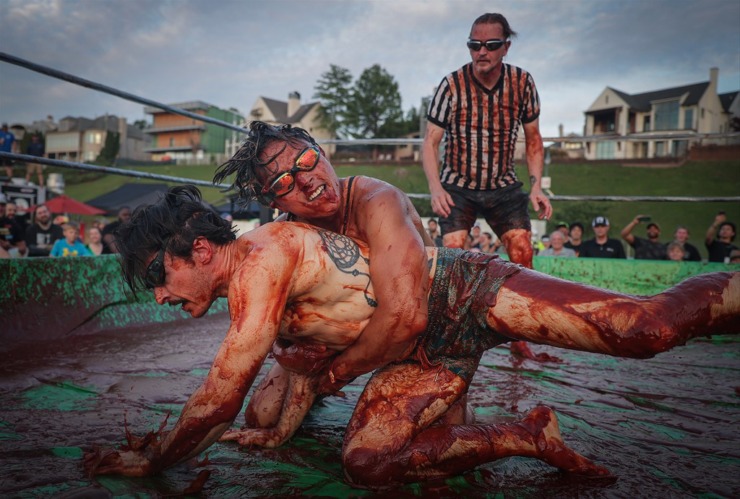 <strong>Hung Nguyen and Chris Coles get sticky as they slide in The World Championship Barbecue Cooking Contest&rsquo;s Sauce Wrestling event May 17, 2023.</strong> (Patrick Lantrip/The Daily Memphian)