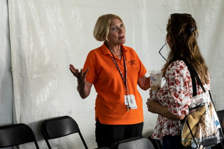 <strong>Mary Horner discusses the state of sauces with a VIP while volunteering at the VIPit tent May 19 during the barbecue contest at Tom Lee Park. </strong>(Brad Vest/Special to The Daily Memphian)