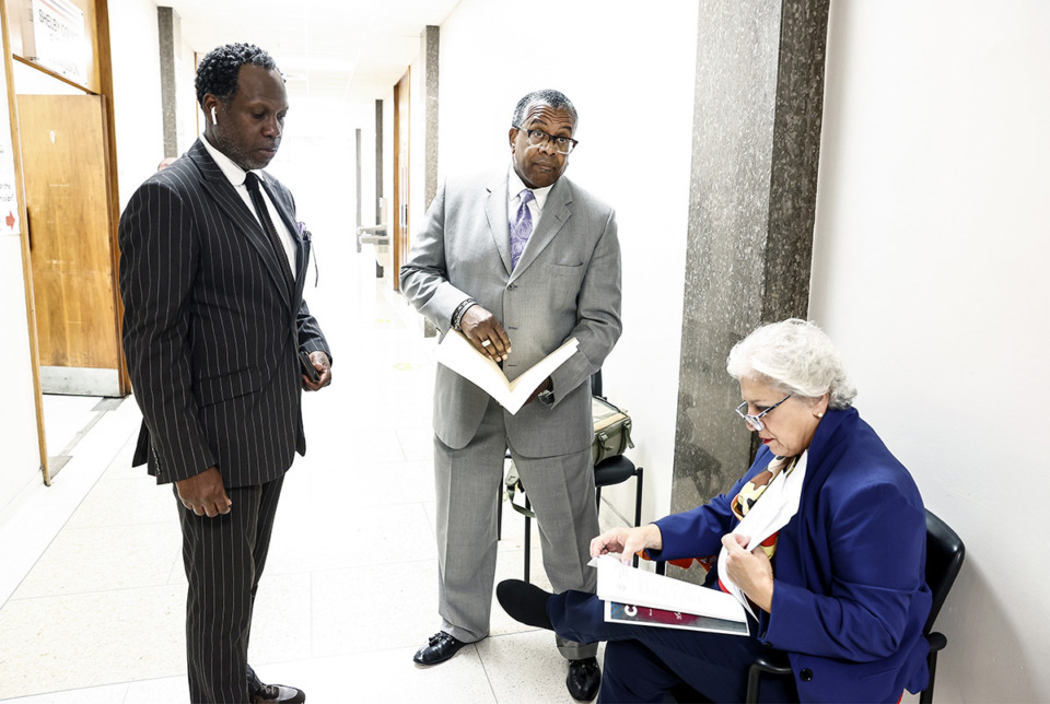 <strong>Mayoral candidate J.W. Gibson (middle) pulls his qualifying petition May 22 with the Shelby County Election Commission.</strong> (Mark Weber/The Daily Memphian)