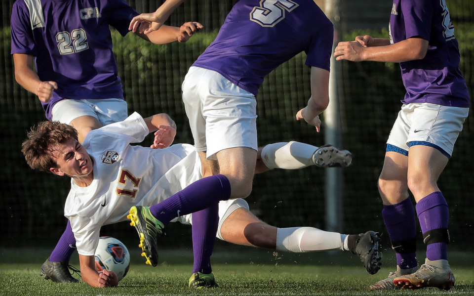 <strong>Evangelical Christian School&nbsp; midfielder Brandon Brackett is knocked around by Christ Presbyterian Academy players while trying to get a shot during the Division 2-A finals at Spring Fling in Murfreesboro on May 22, 2019. Brackett scored one of three goals as ECS blanked CPA for the title.</strong>&nbsp;(Jim Weber/Daily Memphian)