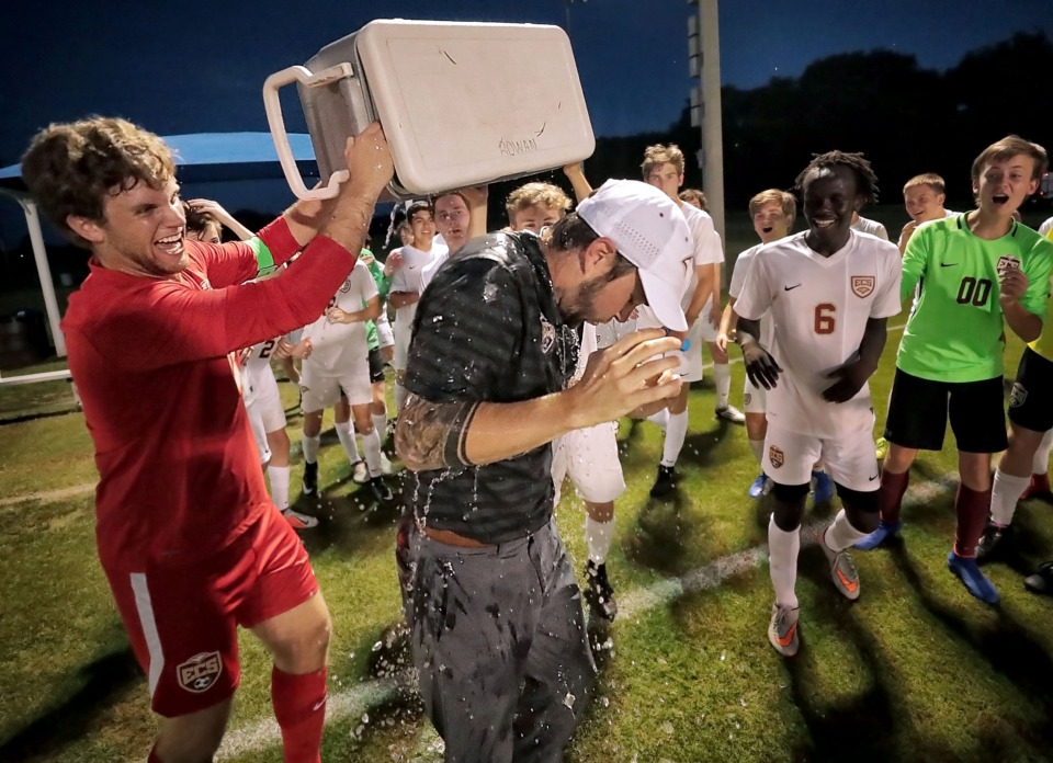 <strong>Goalie Chandler Caughron (left) dumps ice on ECS coach Jordan Thompson after Evangelical Christian School's victory in the Division 2-A soccer championship at Spring Fling in Murfreesboro on May 22, 2019.</strong> (Jim Weber/Daily Memphian)