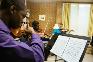 <strong>Olasuyi Ige (from left), Kenneth Gillespie and Noel Medford rehearse at a PRIZM summer camp.</strong>&nbsp;<strong>Ige, a 2018 Overton High graduate, first attended the PRIZM summer festival in 2014. He now attends the Lamont School of Music at the University of Denver on a music scholarship.&nbsp;</strong>(Photo courtesy of David Roseberry)