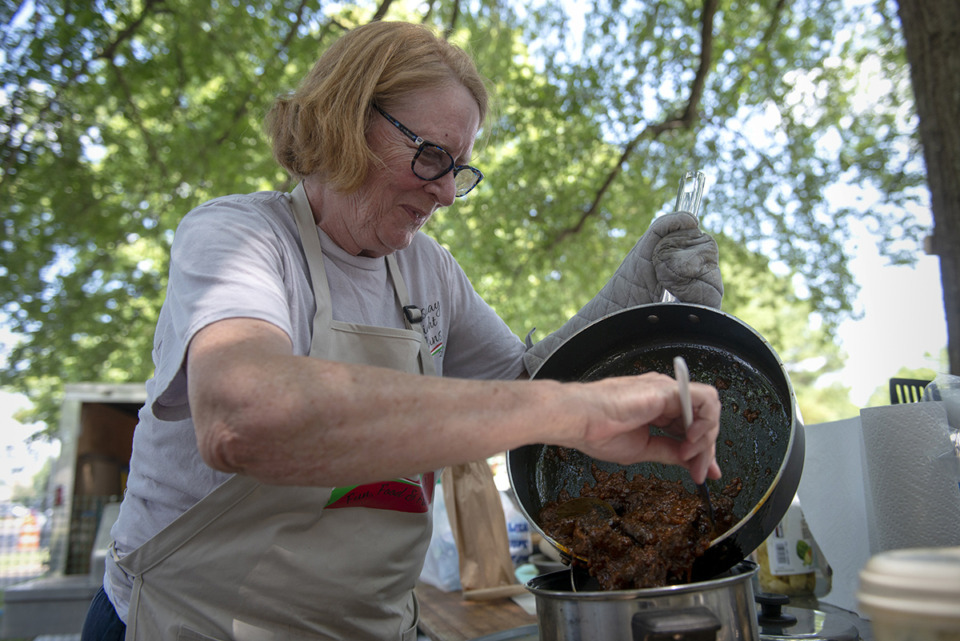 <strong>Mary Wilder works on the spaghetti gravy her team will enter into competition during the 30th annual Memphis Italian Festival at Marquette Park May 30, 2019.</strong> (Brandon Dill/Special To The Daily Memphian)