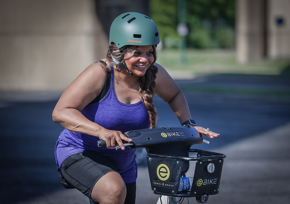 <strong>Tonye Smith-McBride learns how to peddle a bike at a Beginner Biking class hosted by the Downtown Memphis Commission andand Explore Bike Share in the Raymond James parking lot June 3, 2023.</strong> (Patrick Lantrip/The Daily Memphian)