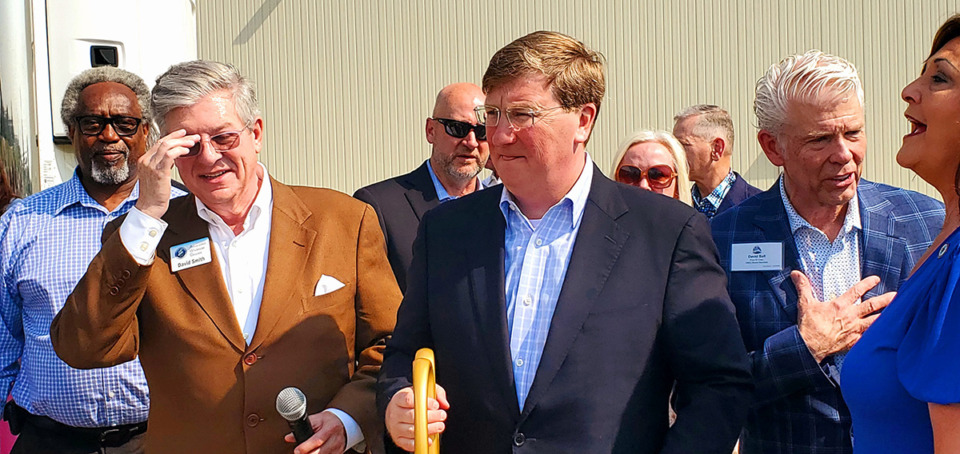 <strong>Mississippi Gov. Tate Reeves (center) mingles with David Smith (left), president and CEO of Associate Wholesale Grocers, and local leaders immediately after finishing up the ceremonial opening of the new state-of-the-art warehouse at Interstate 55 and Interstate 269 in Hernando.</strong> (Toni Lepeska/Special to The Daily Memphian)