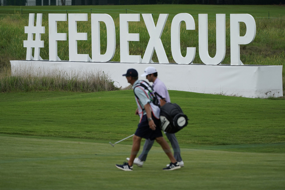 <strong>Plans are moving ahead for the FedEx St. Jude championship in 60 days. A golfer walks past a FedEx Cup sign along the 13th fairway during the first round of the St. Jude Championship golf tournament last August.</strong> (Mark Humphrey/AP Photo)
