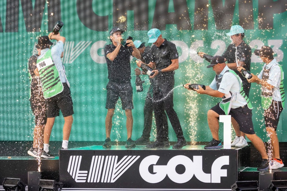 <strong>Team champions David Puig, Sebasti&aacute;n Mu&ntilde;oz, Mito Pereira, Captain Joaqu&iacute;n Niemann of Torque GC and their caddies celebrate on stage with the team trophy during LIV Golf DC at the Trump National Golf Club in Washington Sunday, May 28, 2023, in Sterling, Virginia.</strong> (AP file)