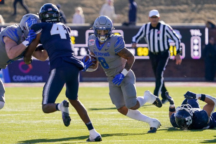 Memphis running back Jevyon Ducker (8) runs with the ball during the first half of the First Responders Bowl NCAA college football game against Utah State, Tuesday, Dec. 27, 2022, in Dallas. (AP Photo/Sam Hodde)