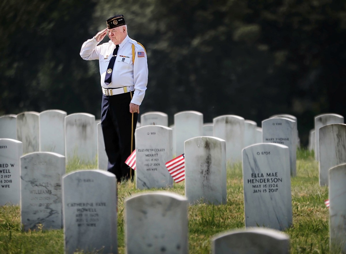 <strong>Vietnam veteran Ron Roberson salutes his parents' grave marker, both of whom served in the military, before the start of the annual Memorial Day ceremony at the West Tennessee State Veterans Cemetery on Monday, May 27.</strong> (Jim Weber/Daily Memphian)