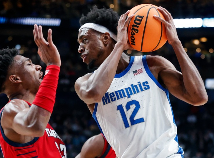 University of Memphis forward DeAndre Williams (right) drives the lane against Florida Atlantic University defender Jack Johnson (left) during action in their NCAA tournament game on Friday, March 17, 2023 in Columbus, Ohio. (Mark Weber/The Daily Memphian)