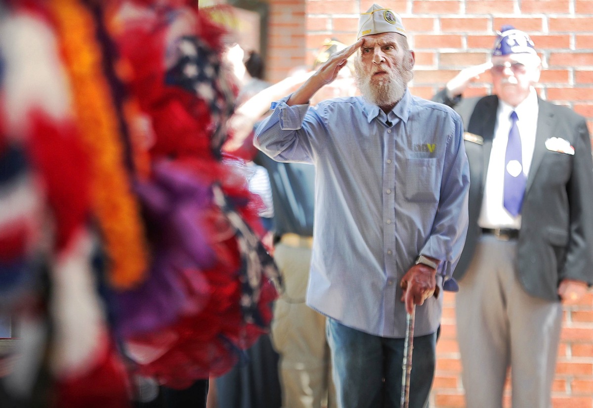 <strong>John Burkhart, 66, who spent 22 years in the military, salutes during "Amazing Grace" at the annual Memorial Day ceremony at the West Tennessee State Veterans Cemetery on Monday, May 27.</strong> (Jim Weber/Daily Memphian)