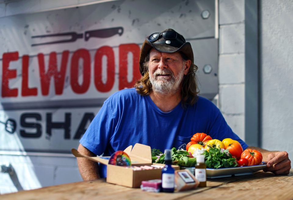 <strong>Tim Bednarski, owner of Elwood's Shack, poses for a portrait at his East Memphis restaurant with fresh produce grown at his east Texas organic farm April 10, 2021.&nbsp;His tomatoes are now raising money for the Special Olympics Greater Memphis.</strong> (Patrick Lantrip/The Daily Memphian file)