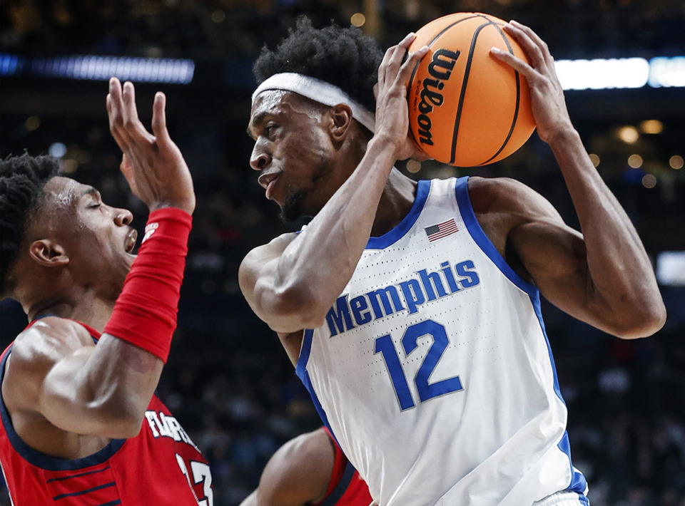 <strong>University of Memphis forward DeAndre Williams (right) drives the lane against Florida Atlantic University defender Jack Johnson (left) during action in their NCAA tournament game on Friday, March 17, 2023 in Columbus, Ohio. Williams is asking the NCAA to allow him eligibility to play for the Tigers again.</strong> (Mark Weber/The Daily Memphian file)