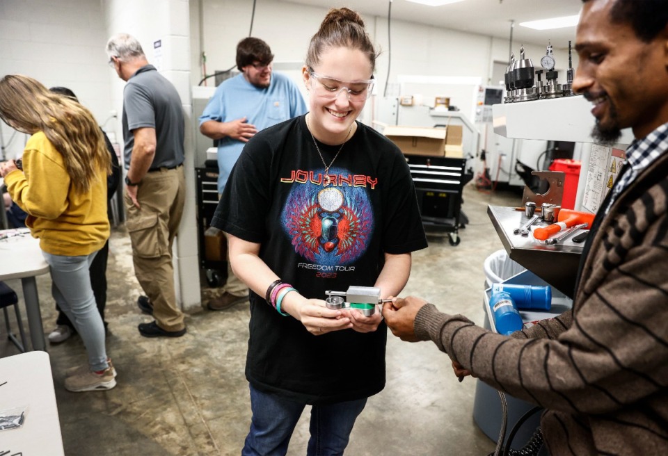 <strong>Abigail O&rsquo;Mara (middle) uses compressed air to test the &ldquo;air machine&rdquo; she made during machining camp on Friday, June 16, 2023, at Arlington High School.</strong> (Mark Weber/The Daily Memphian)