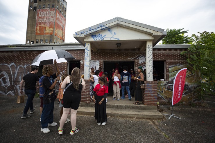 <strong>Festival goers take shelter in front the festival marketplace during scattered rain showers during the Tone Juneteenth Festival in Orange Mound on Sunday, June 18, 2023.</strong> (Ziggy Mack/Special to The Daily Memphian)
