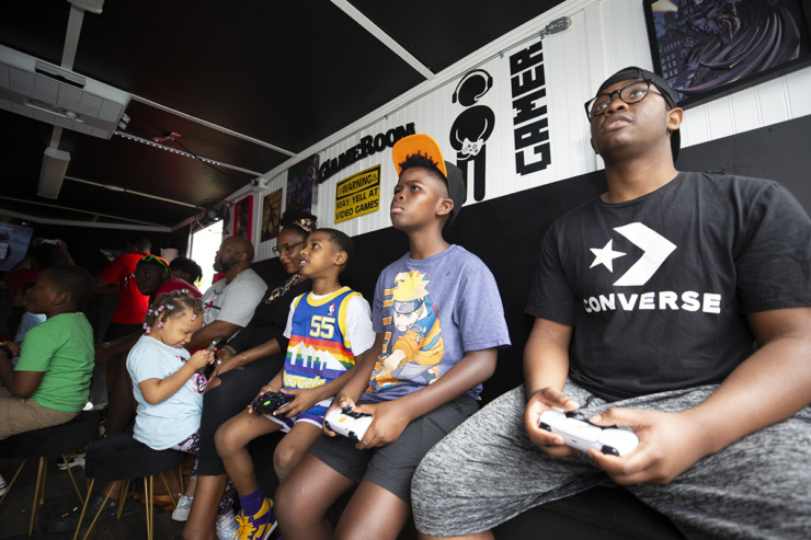<strong>Ashton Buford (right) plays video games along with others in the gamers tent at the Tone Juneteenth Festival in Orange Mound on Sunday, June 18, 2023.</strong> (Ziggy Mack/Special to The Daily Memphian)