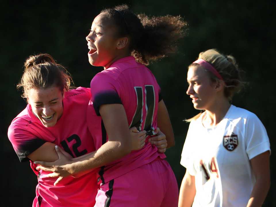 Mustang teammates Parker Gelinas and Amaya Andrews celebrate after Andrews scored against ESC during Houston High School's soccer game against ECS at Houston Middle School on August 28, 2018. (Jim Weber/Daily Memphian)