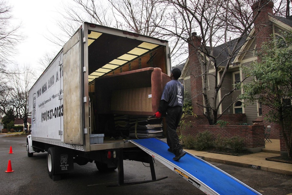 <strong>Movers from Two Men and a Truck load a sofa onto a truck.</strong> (Lance Murphey/The Daily Memphian file)
