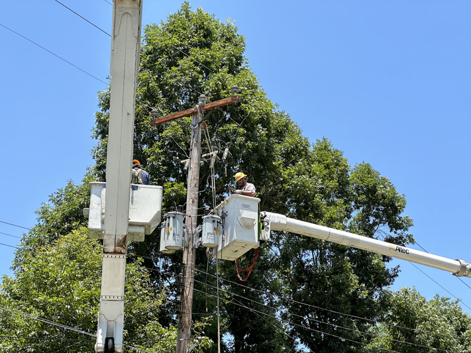 <strong>A Memphis Light, Gas and Water crew in a truck works on a damaged utility pole Thursday, June 29.</strong> (Keely Brewer/The Daily Memphian)