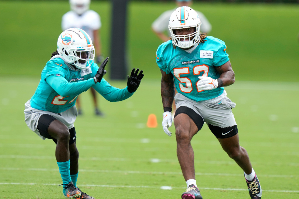 <strong>Miami Dolphins linebacker Aubrey Miller (52) and&nbsp;cornerback Keion Crossen (left), run drills during practice at the NFL football team's training facility, Wednesday, May 31, 2023, in Miami Gardens, Fla.</strong> (Lynne Sladky/AP file)