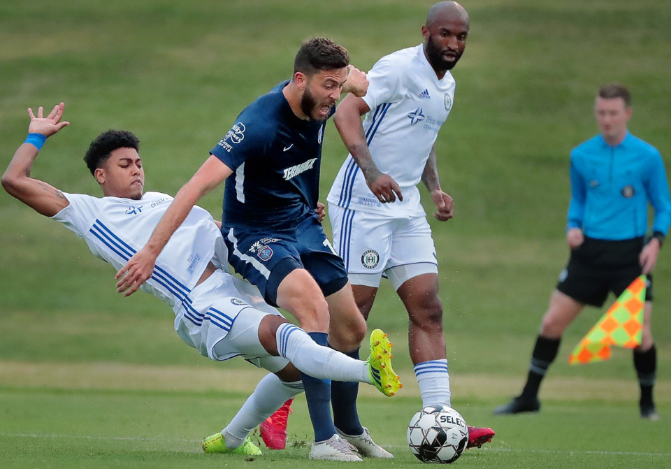 <strong>Defender Logan Gdula (left) trips up Memphis forward Elliot Collier during 901 FC's third-round win over the Hartford Athletic during their Lamar Hunt U.S. Open Cup tournament game at the Mike Rose Soccer Complex on May 29, 2019.</strong>&nbsp;<strong>Memphis won 4-0.&nbsp;</strong>(Jim Weber/Daily Memphian)