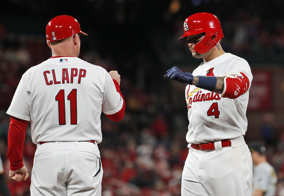<strong>St. Louis Cardinals' Yadier Molina (4) is congratulated by first base coach Stubby Clapp after hitting an RBI single during the fourth inning of the team's baseball game against the Pittsburgh Pirates on Thursday, May 9, 2019, in St. Louis.</strong> (Jeff Roberson/AP Photo file)