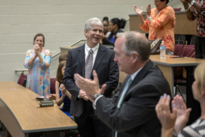 <strong>Gary Lilly (center) acknowledges the applause after being named new superintendent of Collierville Schools during a special meeting at Collierville High School on May 30, 2019.</strong> (Brandon Dill/Special To The Daily Memphian)