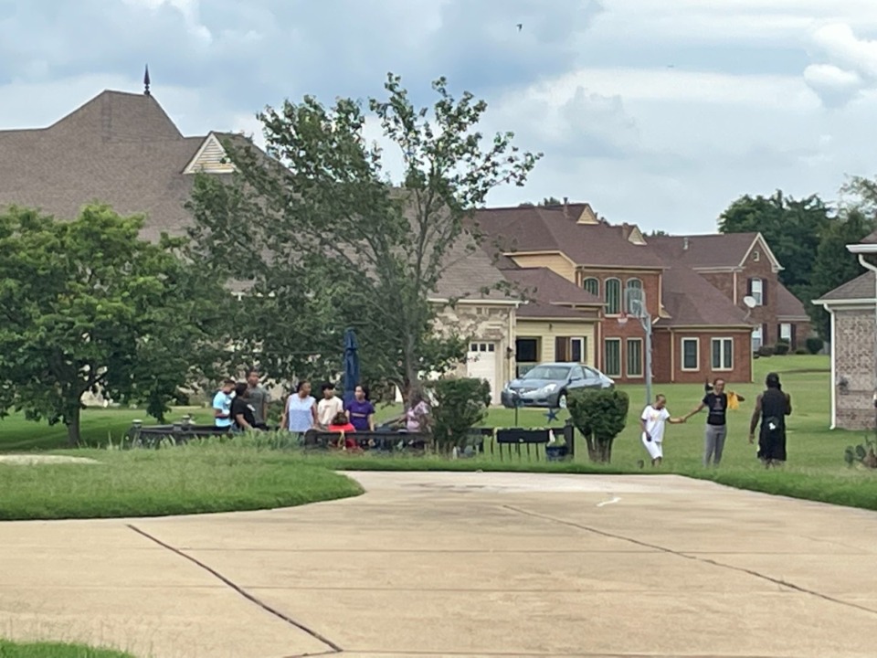 <strong>Residents in the Laurel Tree subdivision gather Friday afternoon near Jamieson Lake.</strong> (The Daily Memphian)