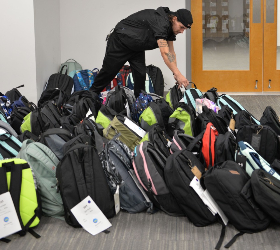 <strong>Volunteer Brett Houle helps witih the Backpack Heroes program.</strong> (Courtesy Youth Villages)