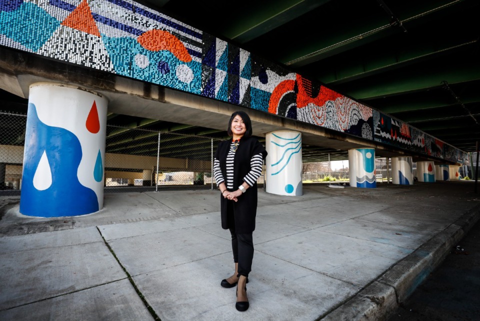 <strong>Artist Kong Wee Pang stands by her completed public art installation on North Main Street under the I-40 underpass north of Renasant Convention Center Thrusday, Dec. 23, 2021. The installation was completed through an initiative between UrbanArt Commission and Downtown Memphis Commission</strong>. (Mark Weber/Daily Memphian file)