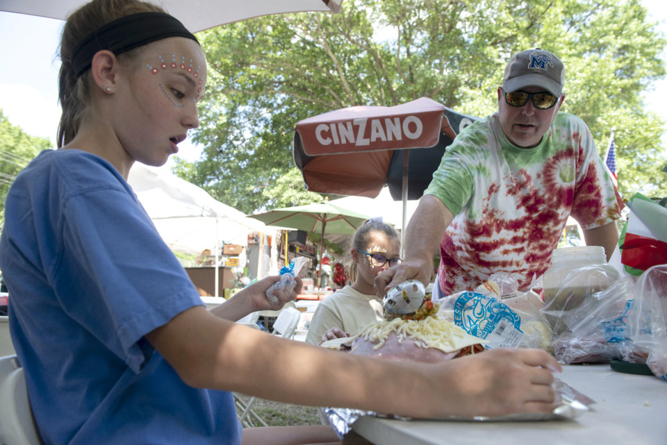 <strong>"Oliveus" members Ainsley Johnston, 13 (from left), Linley Fristick, 12, and Carl Fristick make muffaletta sandwiches during the 30th annual Memphis Italian Festival at Marquette Park on May 30, 2019, in Memphis.</strong> (Brandon Dill/Special To The Daily Memphian)