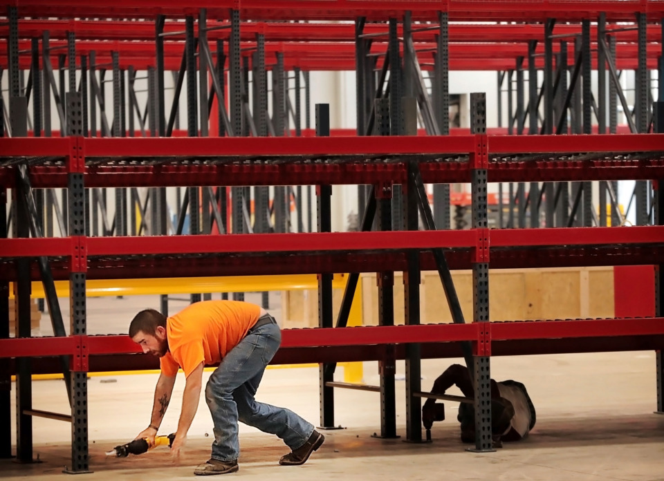 <strong>Justin Yates installs shelving in the main warehouse at the Mid-South Food Bank's new facility on South Perkins, where the Food Bank plans to consolidate it's operations as soon as their occupancy permit is approved. The Food-Bank was one of the grant recipients this year from the Horizon Foundation.</strong> (Jim Weber/Daily Memphian)